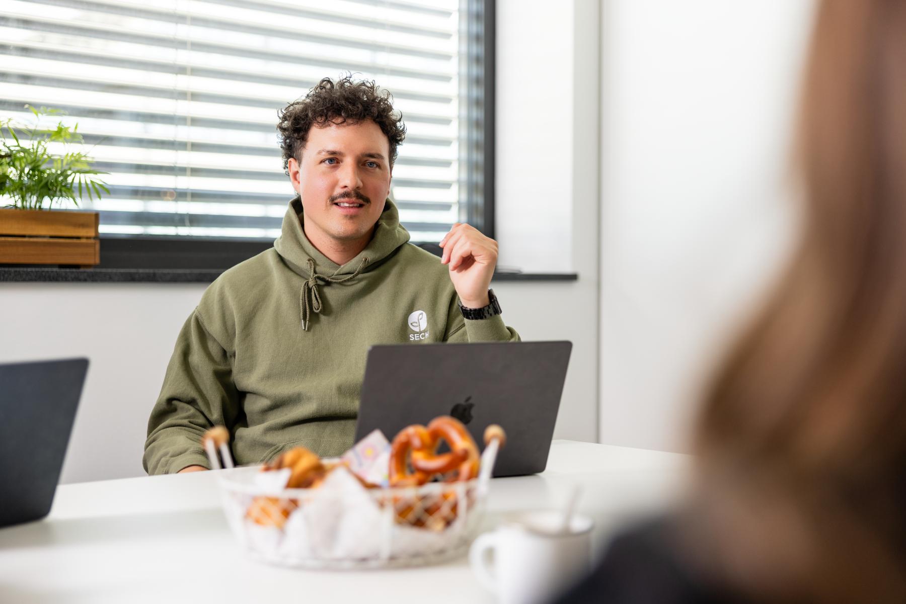 Christoph Gugel mit seinem MacBook in einem Meeting